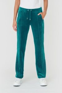 JUICY COUTURE Turkusowe spodnie Tina. Niebieskie spodnie dresowe Juicy Couture, s, bez wzorów, z dresówki. W wyprzedaży za 299,99 zł.