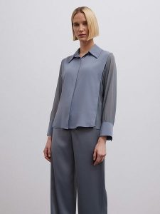 BGN Bluzka w kolorze niebieskoszarym rozmiar: 40. Niebieskie bluzki BGN, bez wzorów, bez kołnierzyka, bez ramiączek. Za 69,75 zł.