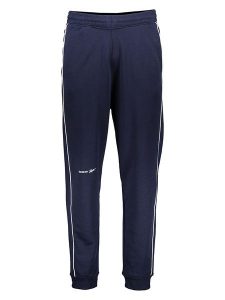 Reebok Spodnie dresowe w kolorze granatowym rozmiar: M. Niebieskie spodnie dresowe Reebok, m, bez wzorów, z dresówki. Za 122,96 zł.