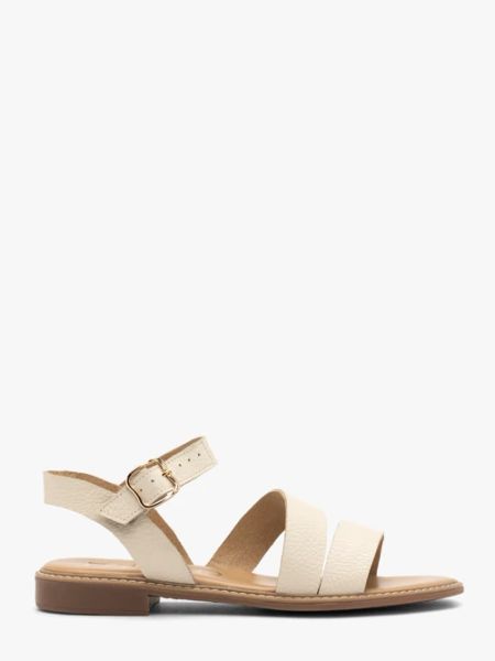 Kremowe sandały damskie. Brązowe sandały Ryłko, bez wzorów, ze skóry, bez obcasa, na płaskiej podeszwie, bez zapięcia. W wyprzedaży za 279,99 zł.